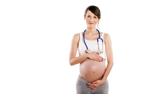 Mulher grávida ouvir com estetoscópio seu bebê. Barriga grávida — Fotografia de Stock