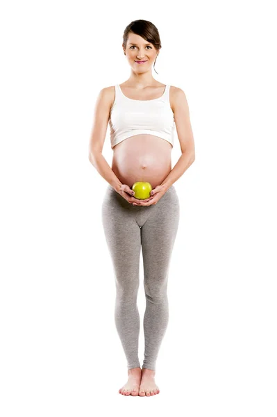 Mujer embarazada aislada sobre fondo blanco, sosteniendo manzana . — Foto de Stock