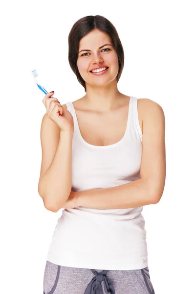 Mujer joven sonriente con dientes sanos sosteniendo un cepillo de dientes —  Fotos de Stock