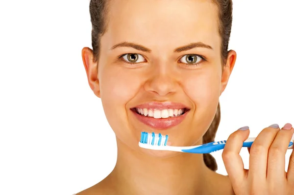 Young woman brushing teeth over white backgrund. Stock Image