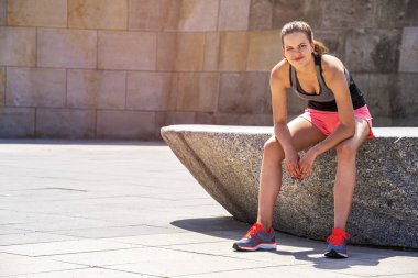 Genç gülümseyen kadın etkin bir antrenman yaparken siti sonra dinlenme