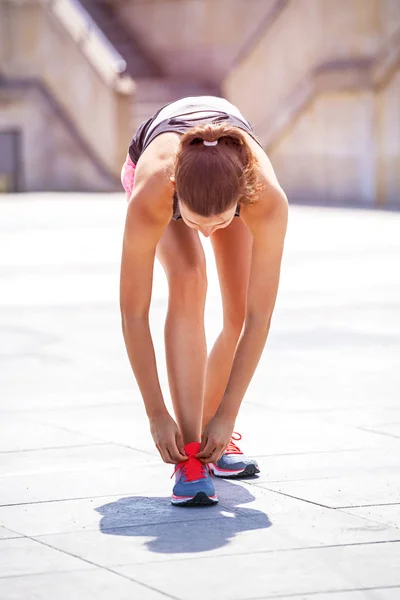 Running shoes - woman tying shoe laces. Female sport fitness run — kuvapankkivalokuva