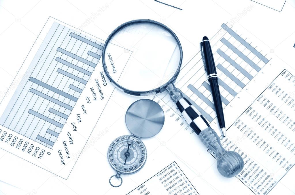 Compass and magnifying glass on the market reports