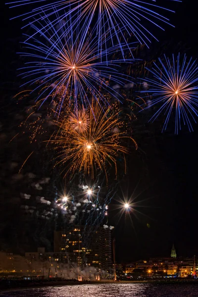 Interesting fireworks over the small town in Spain, Palamos — Stock Photo, Image