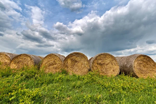Straw bales in raw, strong clouds — Stock Photo, Image