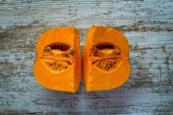 Ripe pumpkin pieces on the gray table — Stock Photo, Image