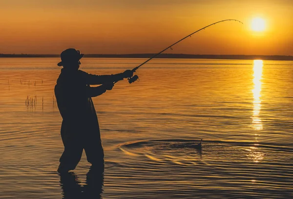 El pescador captura peces para girar y se para en el agua — Foto de Stock