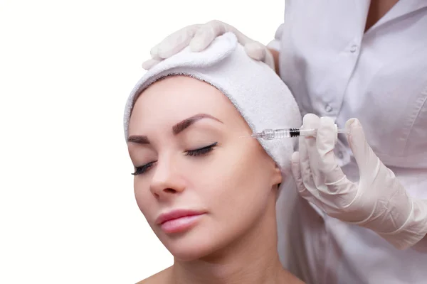 The cosmetologist makes the Botulinotoxin injection procedure for tightening and smoothing wrinkles on the face skin — Stock Photo, Image