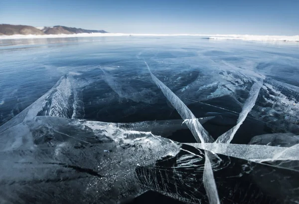 cracks on the ice of a winter lake in winter in Sunny weather