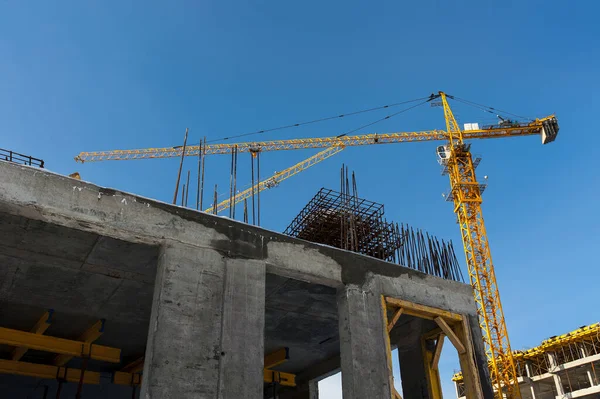 reinforced frame of a new monolithic house under construction against the blue sky