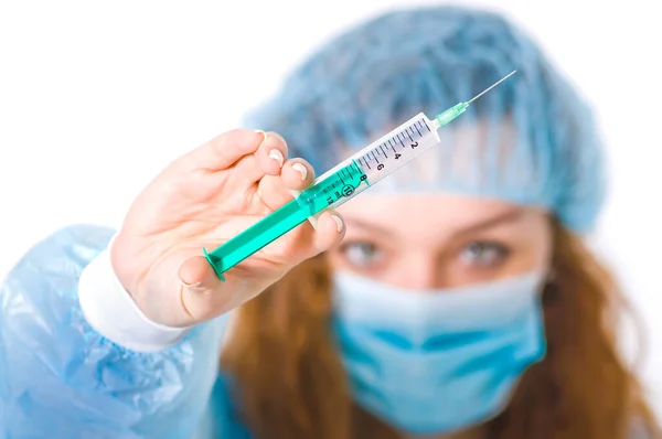 Young Female Doctor Mask Dressing Gown Looks Syringe Her Hand — Stock Photo, Image