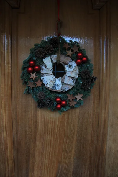 Corona de Navidad con decoraciones en una puerta —  Fotos de Stock