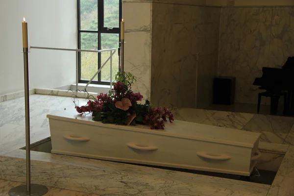 Witte kistje met begrafenis bloemen — Stockfoto