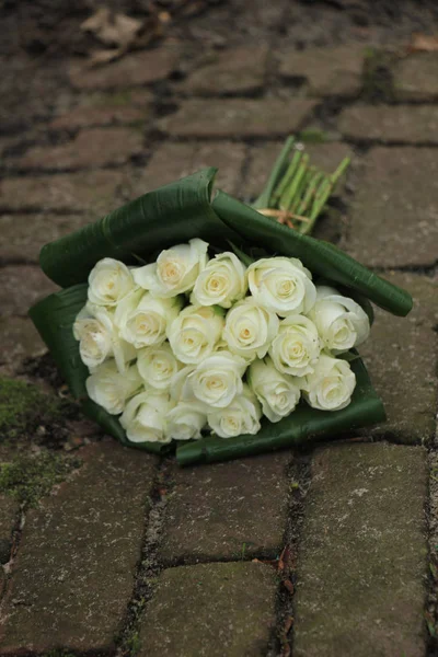 Sympathy bouquet on pavement — Stock Photo, Image