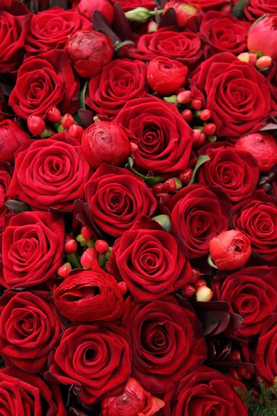 Ranunculus, berries and roses in a group Stock Photo