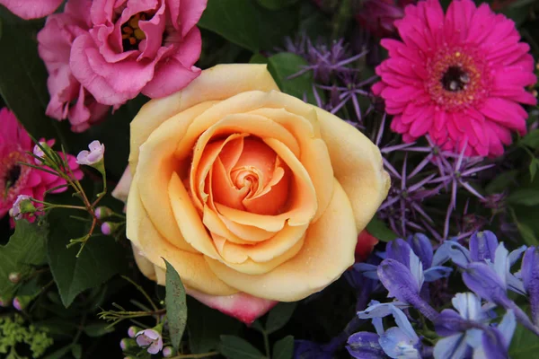 Orange pink rose in a mixed bouquet — Stock Photo, Image