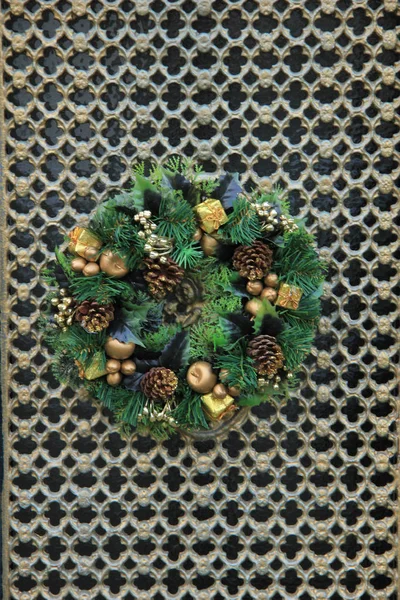 Classic christmas wreath with decorations on a door — Stock Photo, Image