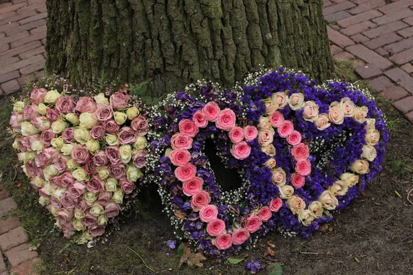 Sympathy flowers near a tree