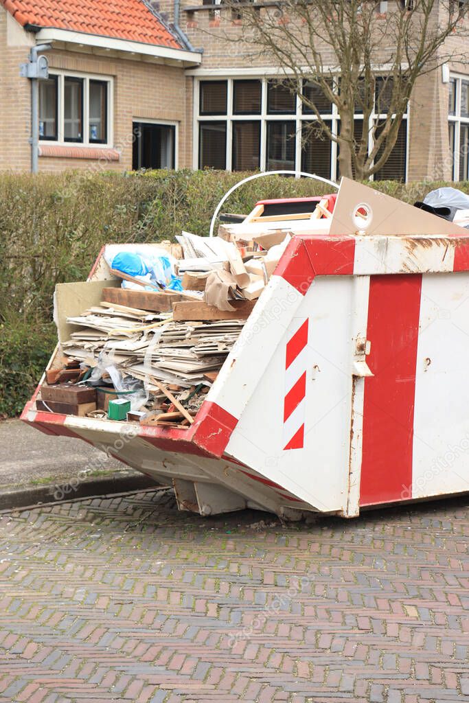 Loaded dumpster near a construction site or home renovation