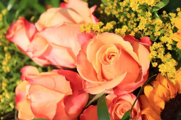 Wedding flowers in yellow and orange: big yellow sunflowers and orange roses