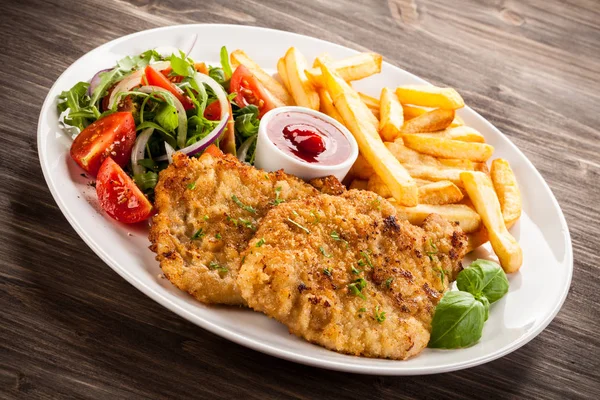 Pork chop, French fries and vegetables — Stock Photo, Image