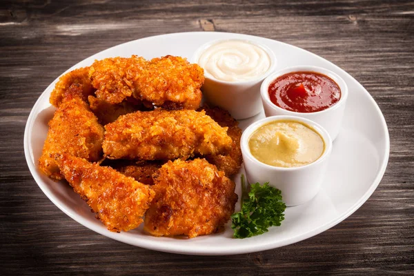 Fried chicken nuggets on wooden background — Stock Photo, Image
