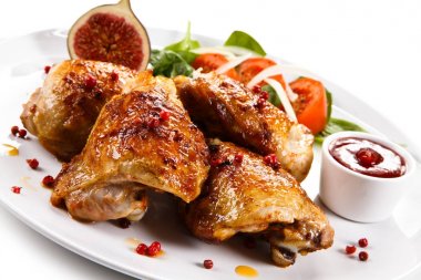 Roasted chicken drumsticks and vegetables clipart
