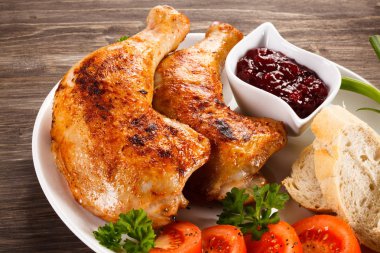 Grilled chicken drumsticks and vegetables clipart