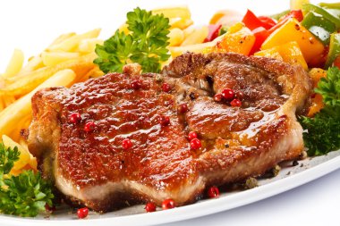 Grilled steak, French fries and vegetables clipart