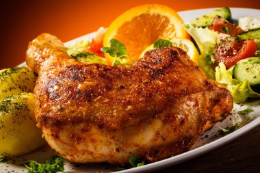 Grillde chicken legs with boiled potatoes and vegetables clipart
