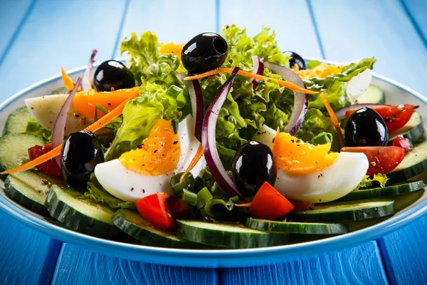 stock image Boiled eggs and vegetables on wooden table