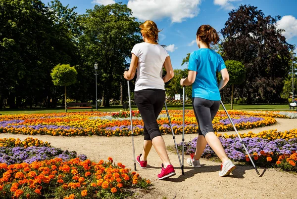 Nordic walking - active people working out in park