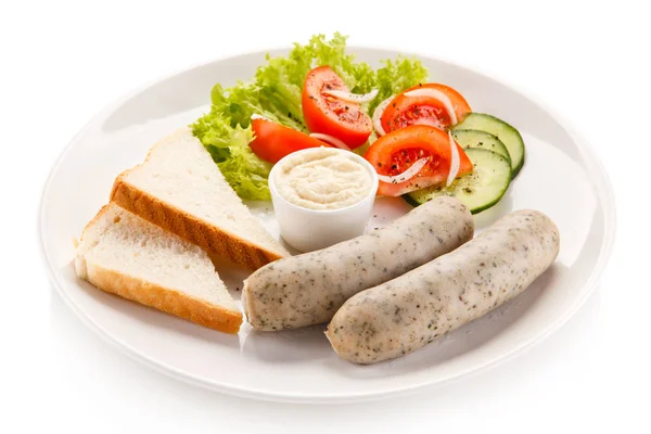 Breakfast - boiled white sausages, toasts and vegetables