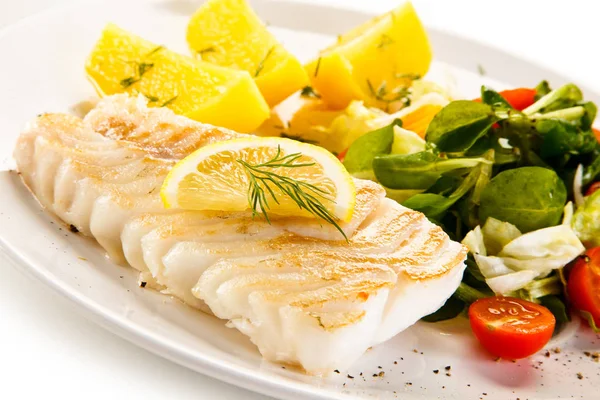 Fish dish - boiled fish fillet, baked potatoes and vegetables