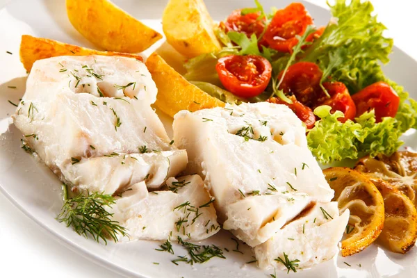 Fish dish - boiled fish fillet, baked potatoes and vegetables