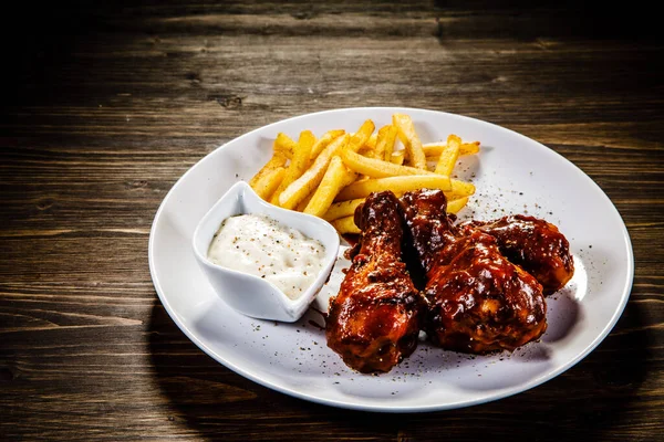 Spicy chicken wings with mayonnaise and french fries