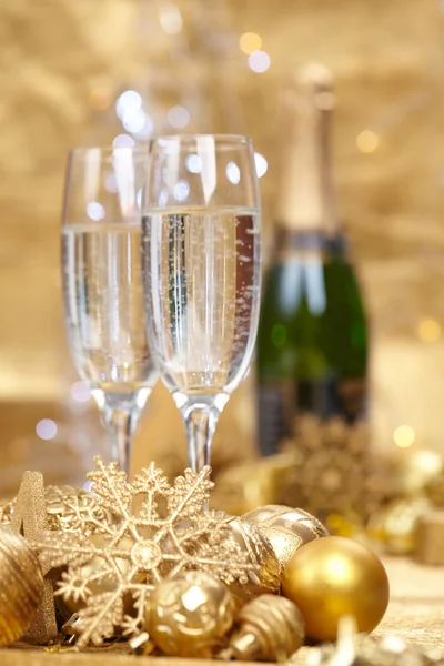 Champagne glasses and New Year decor — Stock Photo, Image