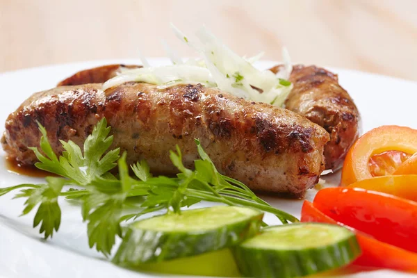 Tasty sausages with vegetables — Stock Photo, Image