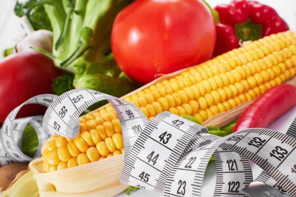 Vegetables with measure tape — Stock Photo, Image