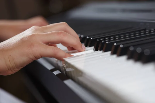 Female's  hands playing piano — Stock Photo, Image