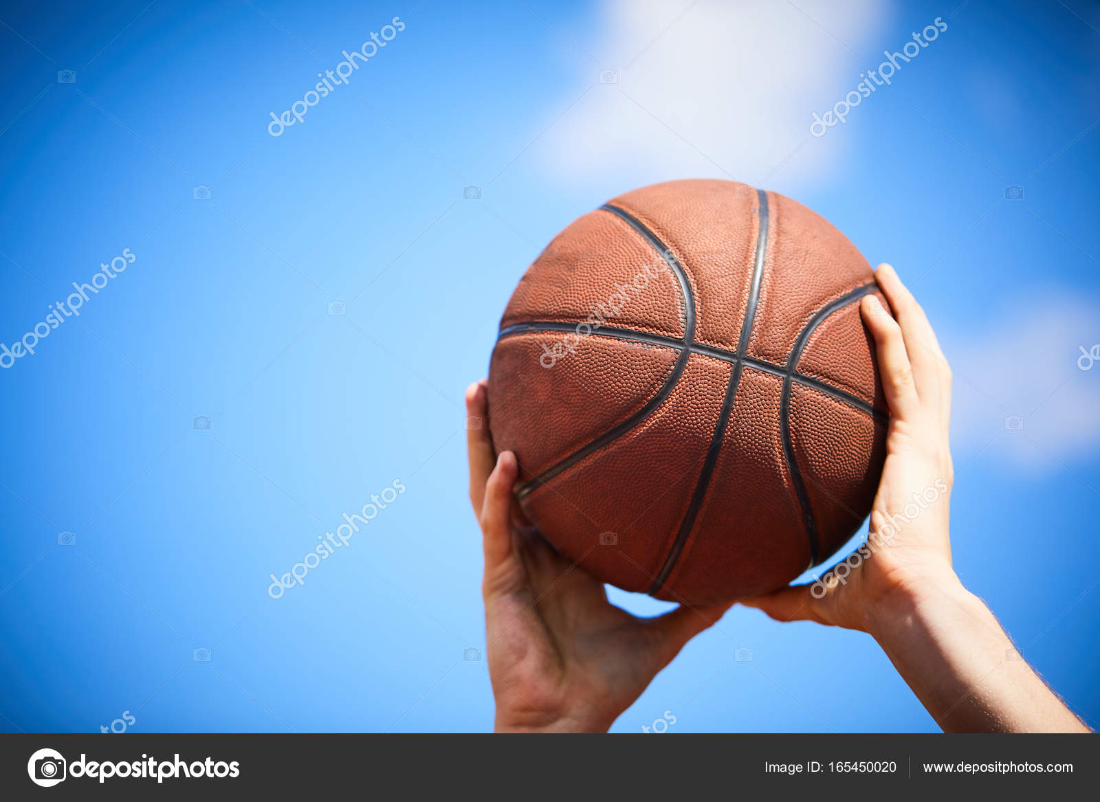 Hands holding basketball ball Stock Photo by ©strelok 165450020