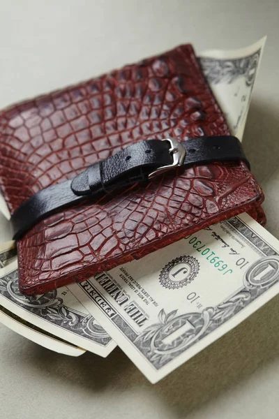 Wallet with money wrapped with belt — Stock Photo, Image