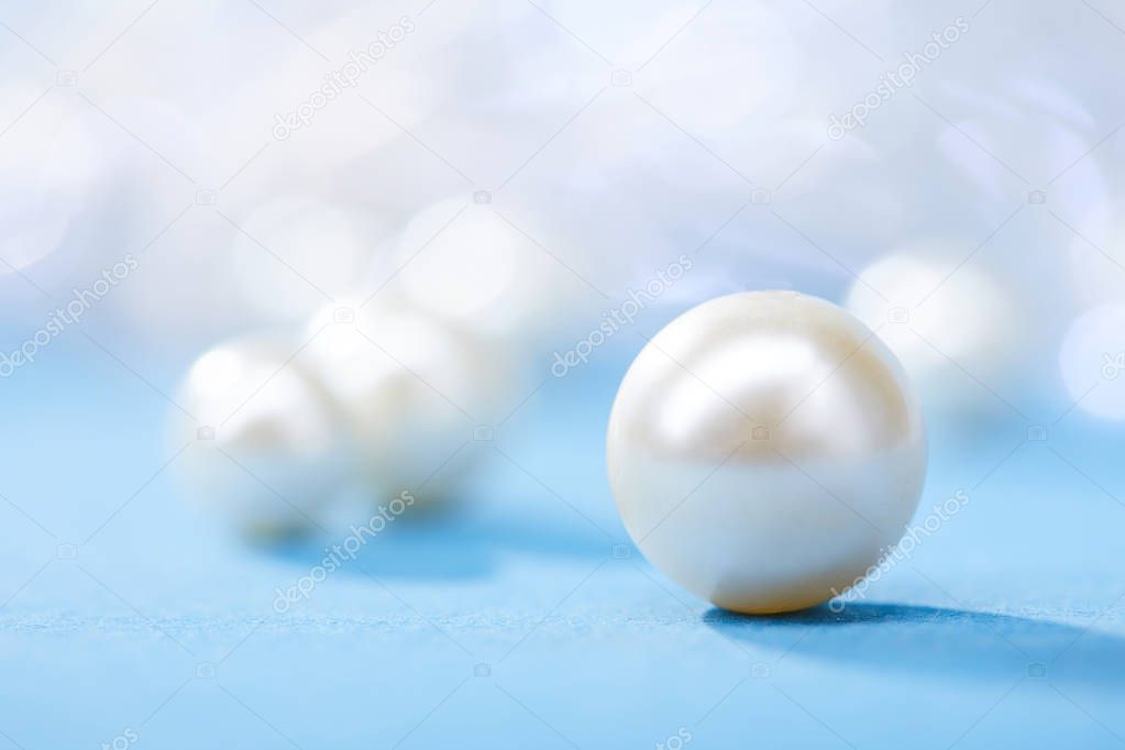beautiful rare pearls on blue background