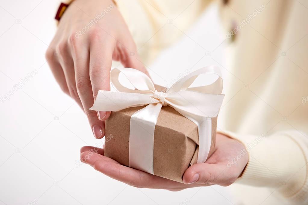 hands holding handmade gift box, close-up