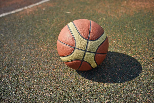 new basketball ball on asphalt road