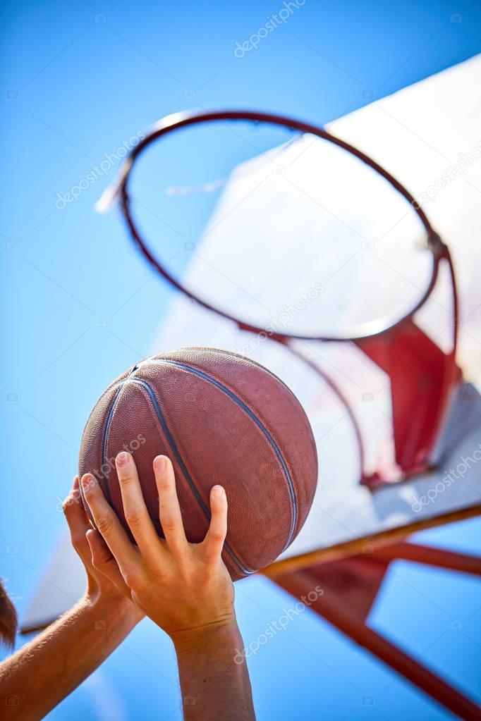 man playing basketball ball, close-up 