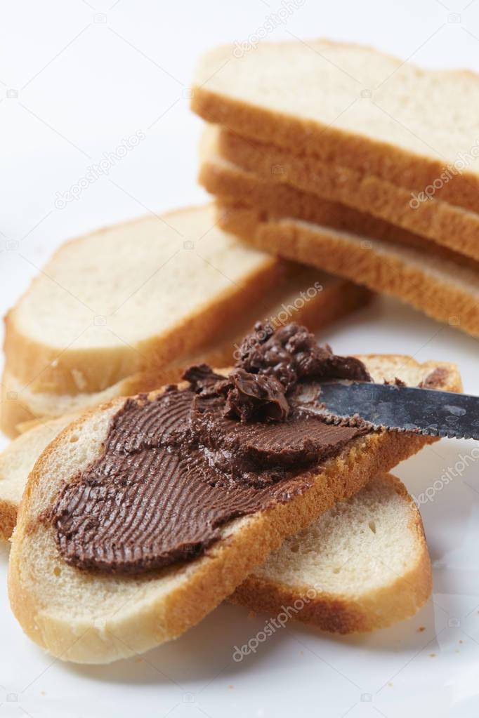 bread with chocolate cream isolated on white background, close-up 