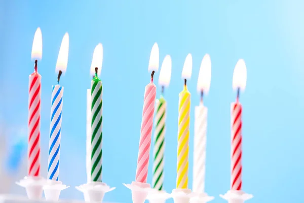 colorful birthday candles on blue background