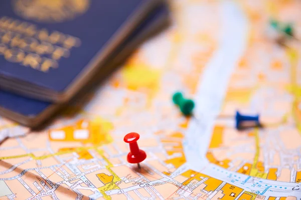 pins marking travel itinerary points on map with passports