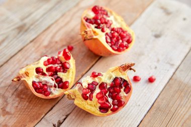 ripe organic pomegranate on wooden background, close-up 